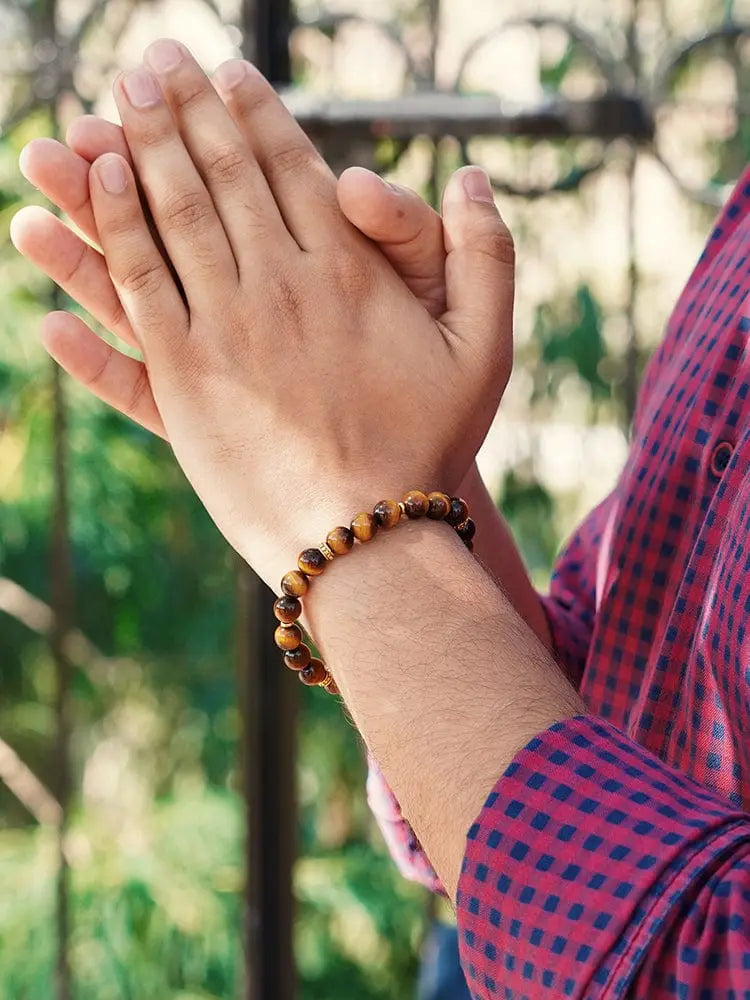 Mykonos tiger eye beaded bracelet with gold accents in warm earthy tones worn on a wrist
