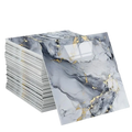 Stack of waterproof tile stickers with adhesive backing featuring glossy gray and white marble pattern with gold veining