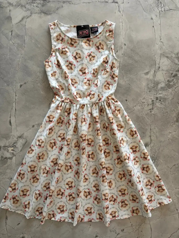 Sleeveless cream cotton vintage dress with repeating cartoon bear pattern and floral details till the cows come home design