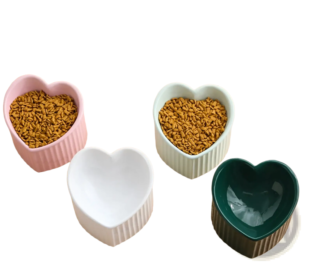 Set of four heart-shaped ceramic cat bowls in pink white light green and dark green with vertical ridged texture