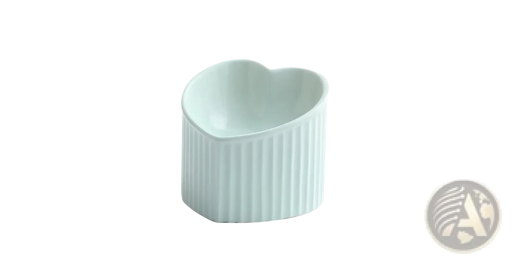 A light blue ceramic cat bowl with vertical ridges and a heart-shaped top from the tilted ceramic cat bowl set