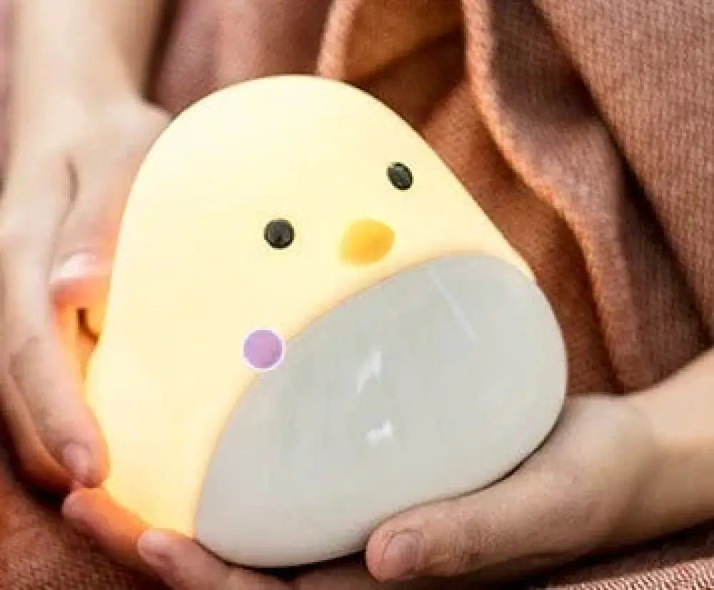 Time bird smart penguin digital clock and night light shaped like a soft glowing yellow and gray chick with black eyes and orange beak