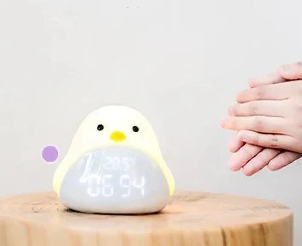 Time Bird smart penguin digital clock and night light in white and yellow plush with led display showing time