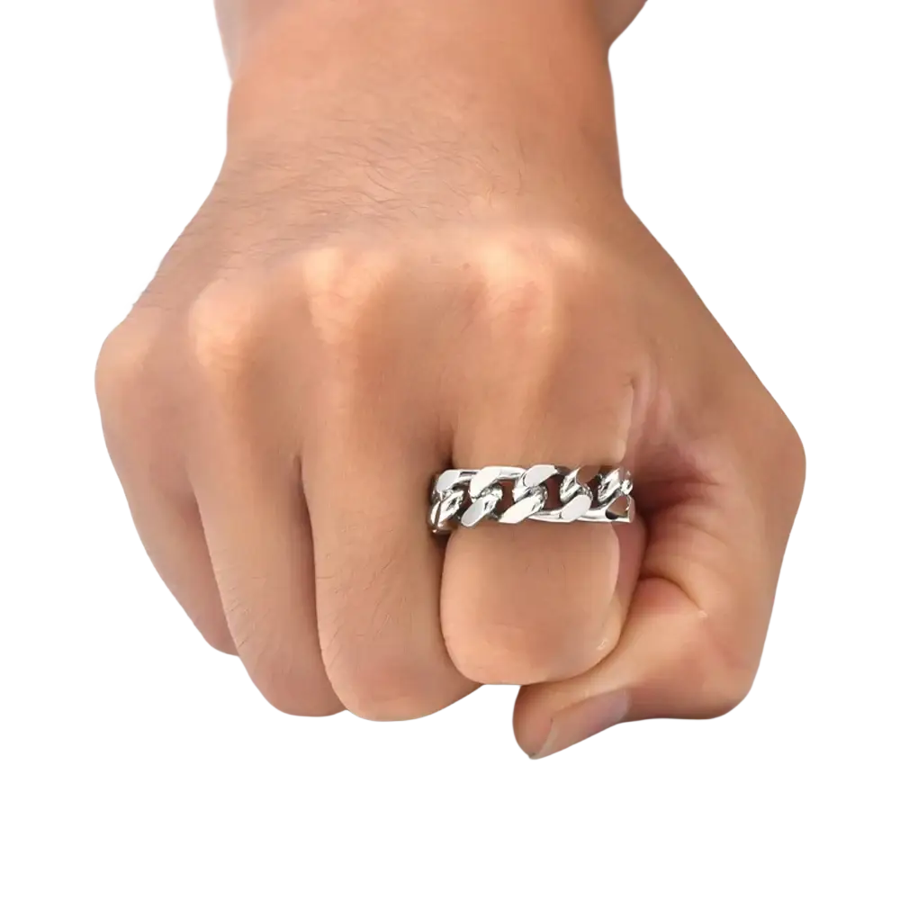 Silver-toned titanium steel cuban chain ring on a clenched fist showcasing a steel cuban chain design