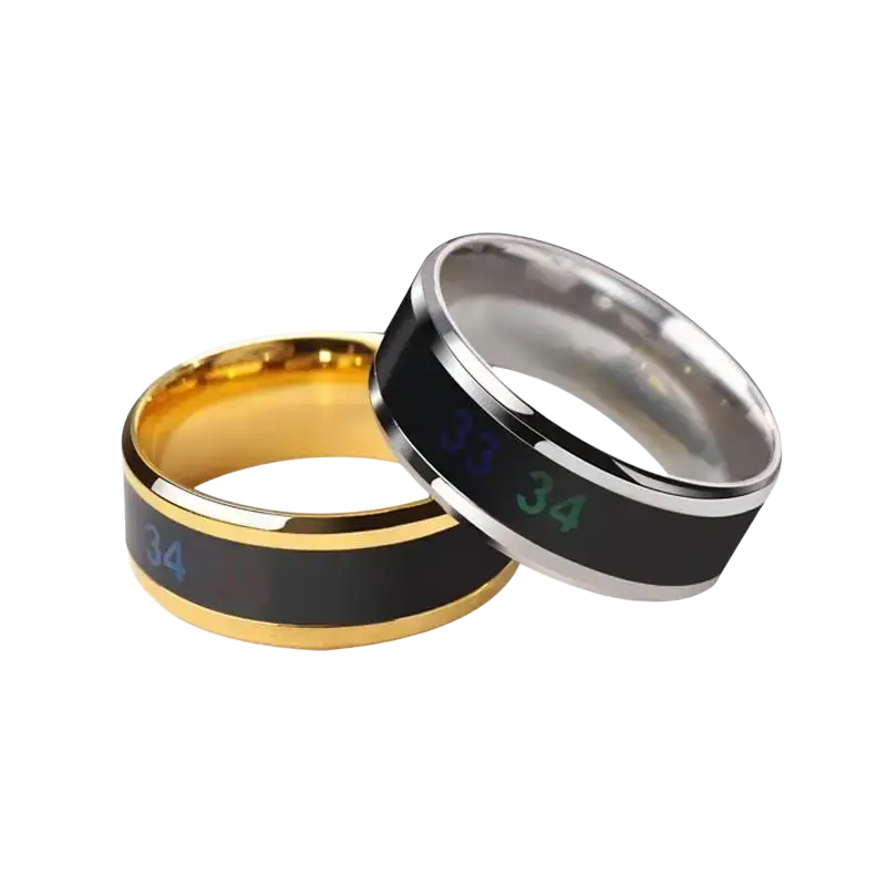Two sleek gold and silver titanium temperature sensitive mood rings with black inlays displaying glowing green numbers