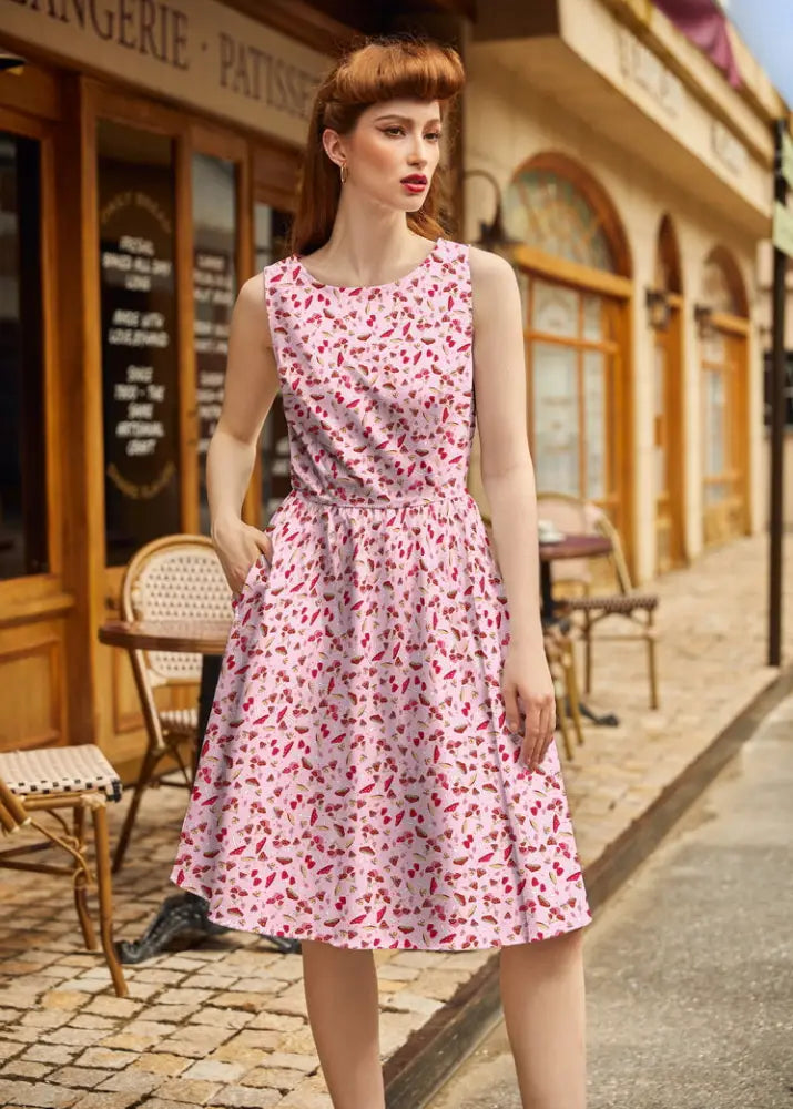 1950s toadstool print pink cotton sleeveless a-line dress with red lipstick pattern and fitted waist