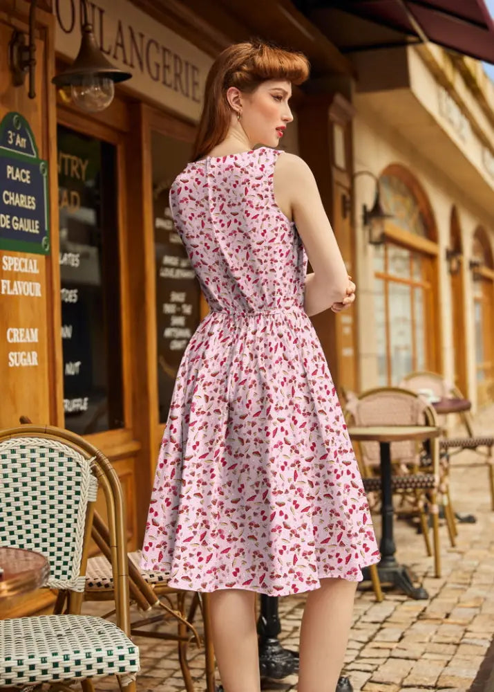 A pink and white floral print sleeveless cotton a-line dress with fitted waistband vintage 1950s toadstool style