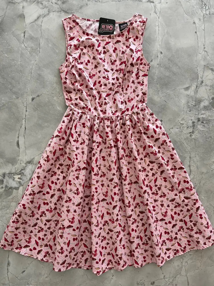A pink sleeveless 1950s vintage cotton dress with cherry print fitted bodice and flared A-line skirt