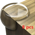 Transparent furniture corner protector made of smooth silicone with rounded corners and a slightly raised edge