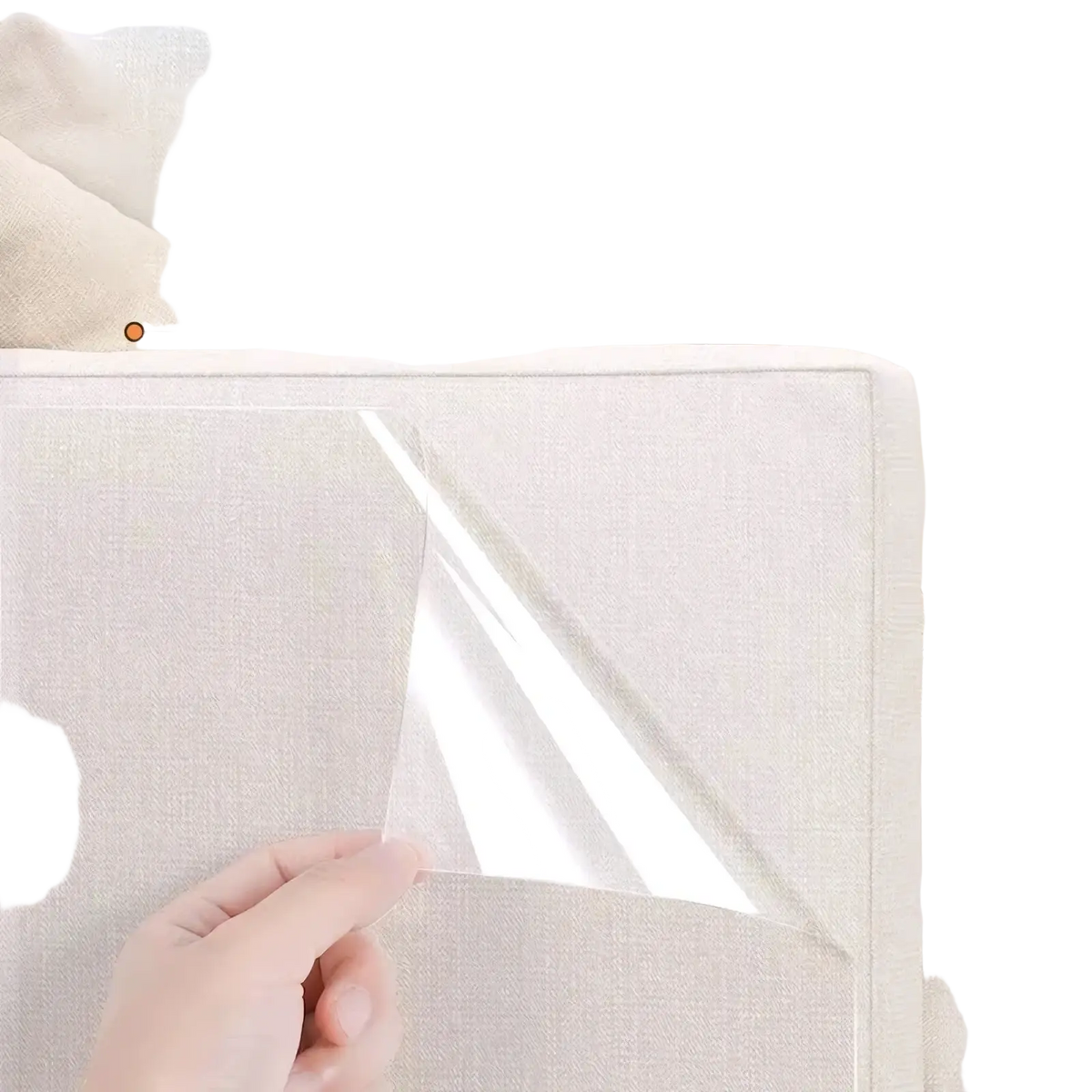 Clear transparent protective film being peeled from beige fabric sofa cushion showing transparent furniture protection film scratch shield