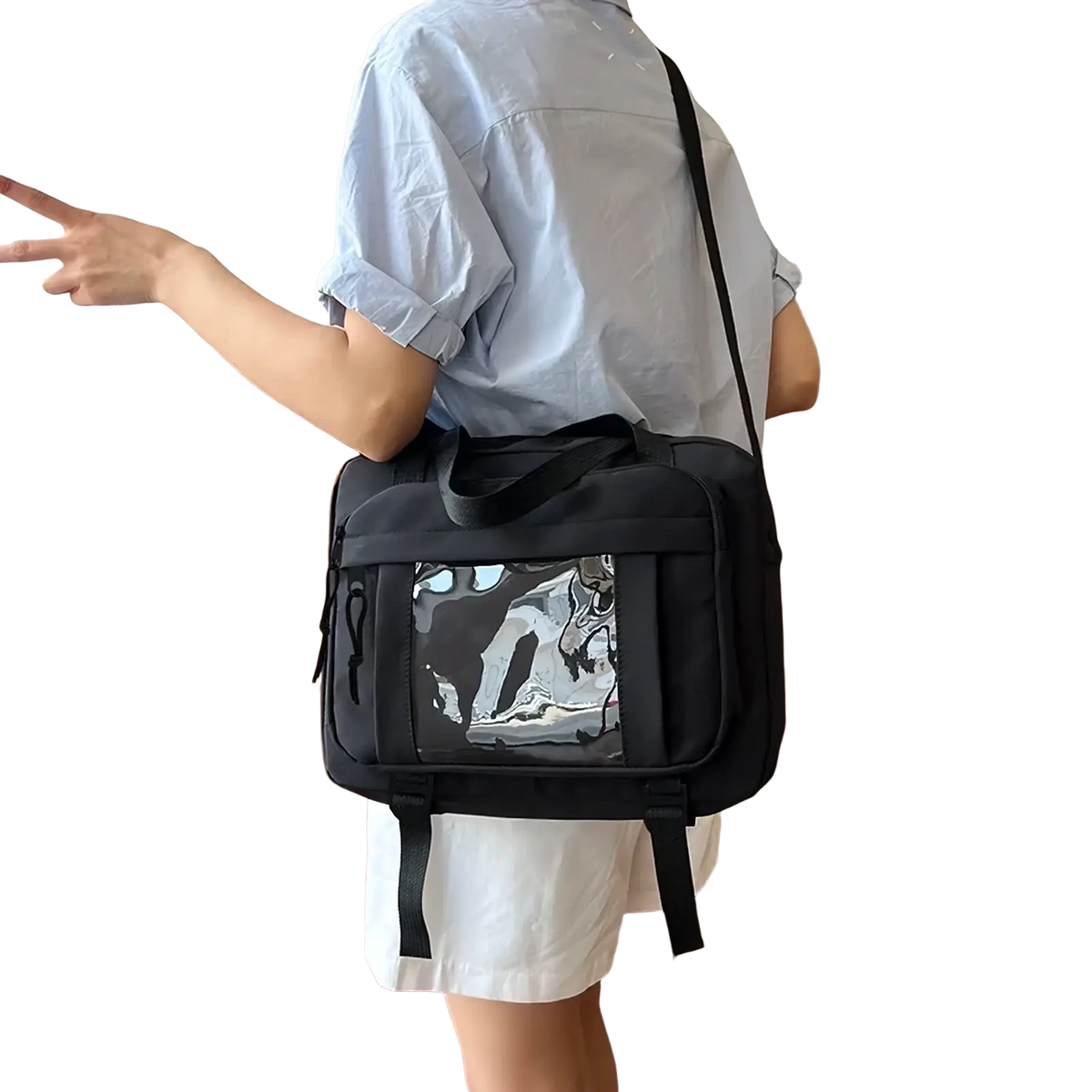 Black canvas travel messenger bag with transparent front panel featuring black and white graphic design