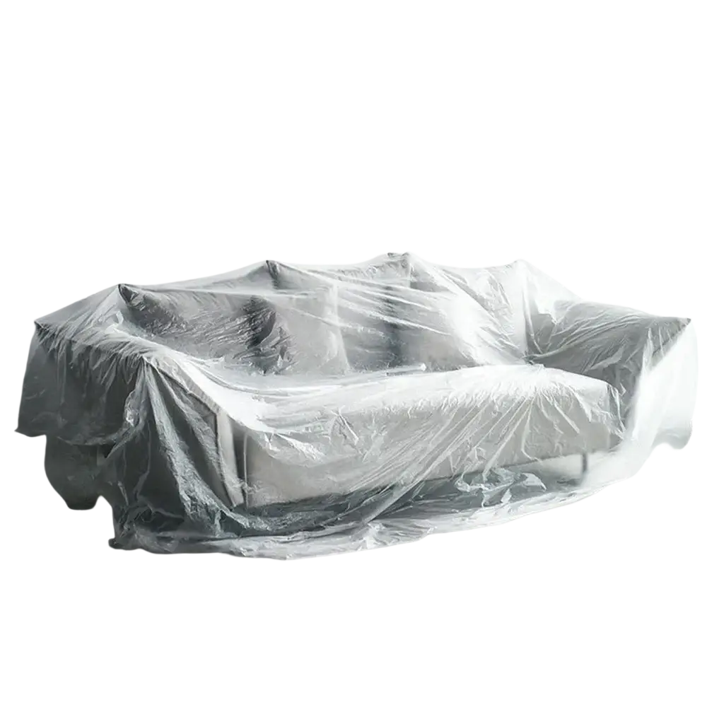 Transparent plastic furniture dust cover film made of clear plastic dustproof film covering a gray sofa