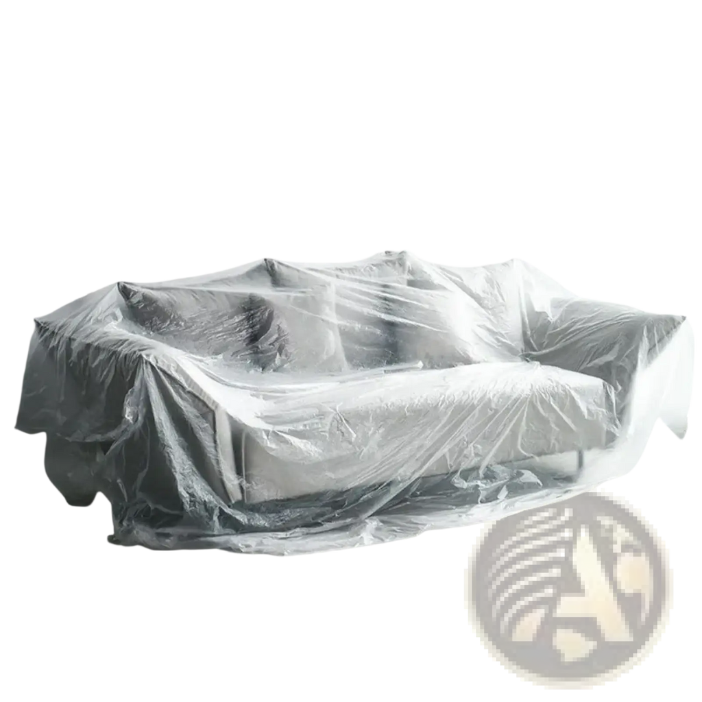 A transparent plastic furniture dust cover protection film draped over a gray upholstered sofa for protection