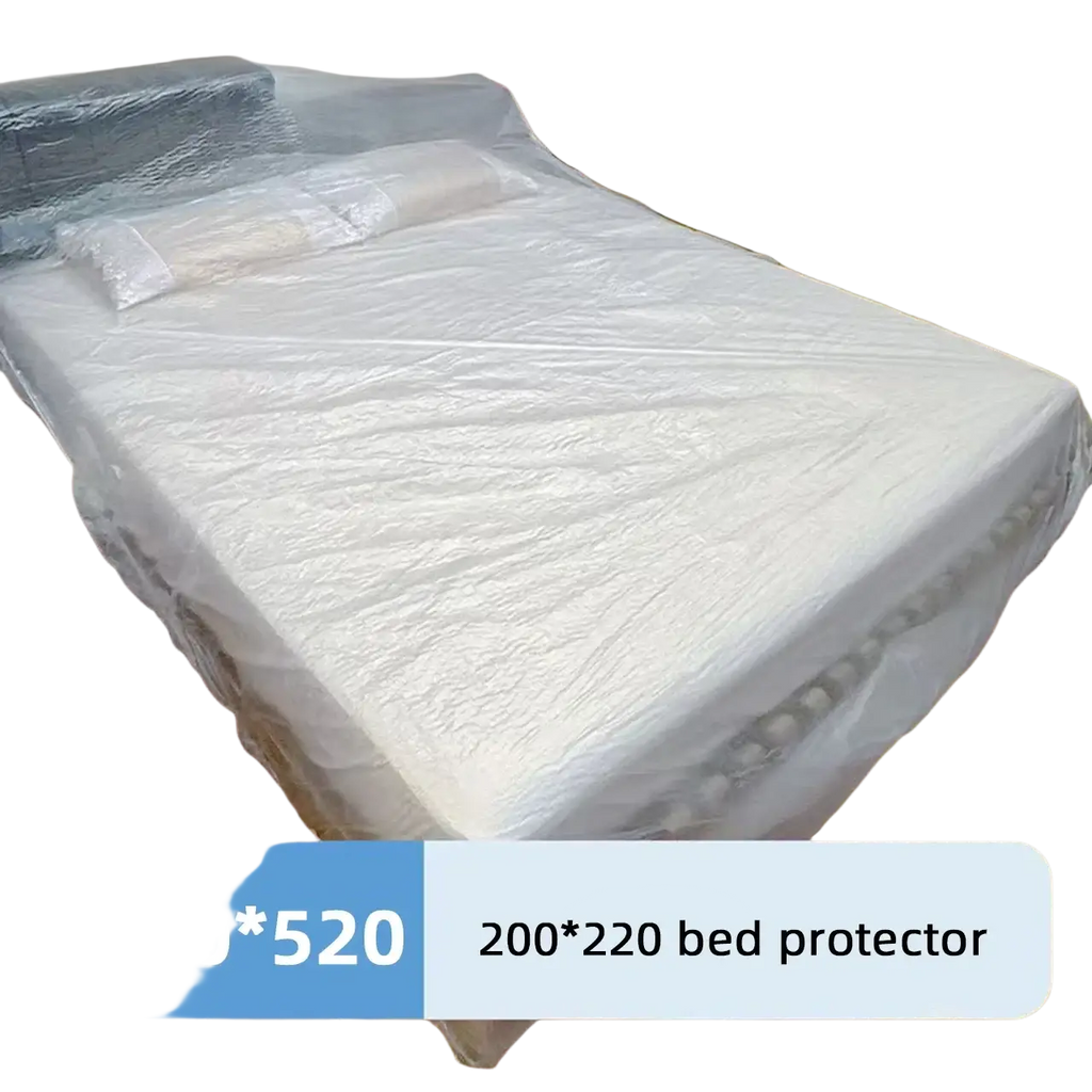 White plastic bed protector with textured surface and reinforced edges covering mattress and pillows for dust protection