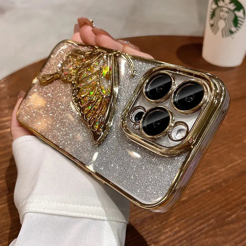 Back side of a shatterproof quicksand butterfly crystal phone case with a glittering gold butterfly and silver base for iPhone