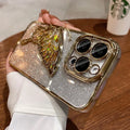 Back side of a shatterproof quicksand butterfly crystal phone case with a glittering gold butterfly and silver base for iPhone