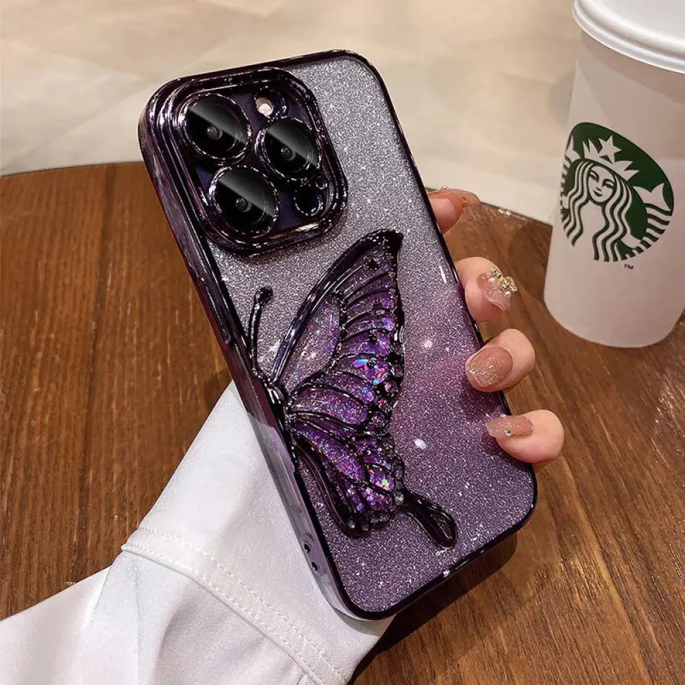 A sparkling purple shatterproof quicksand butterfly crystal phone case with glittery texture and black accents shown from the back