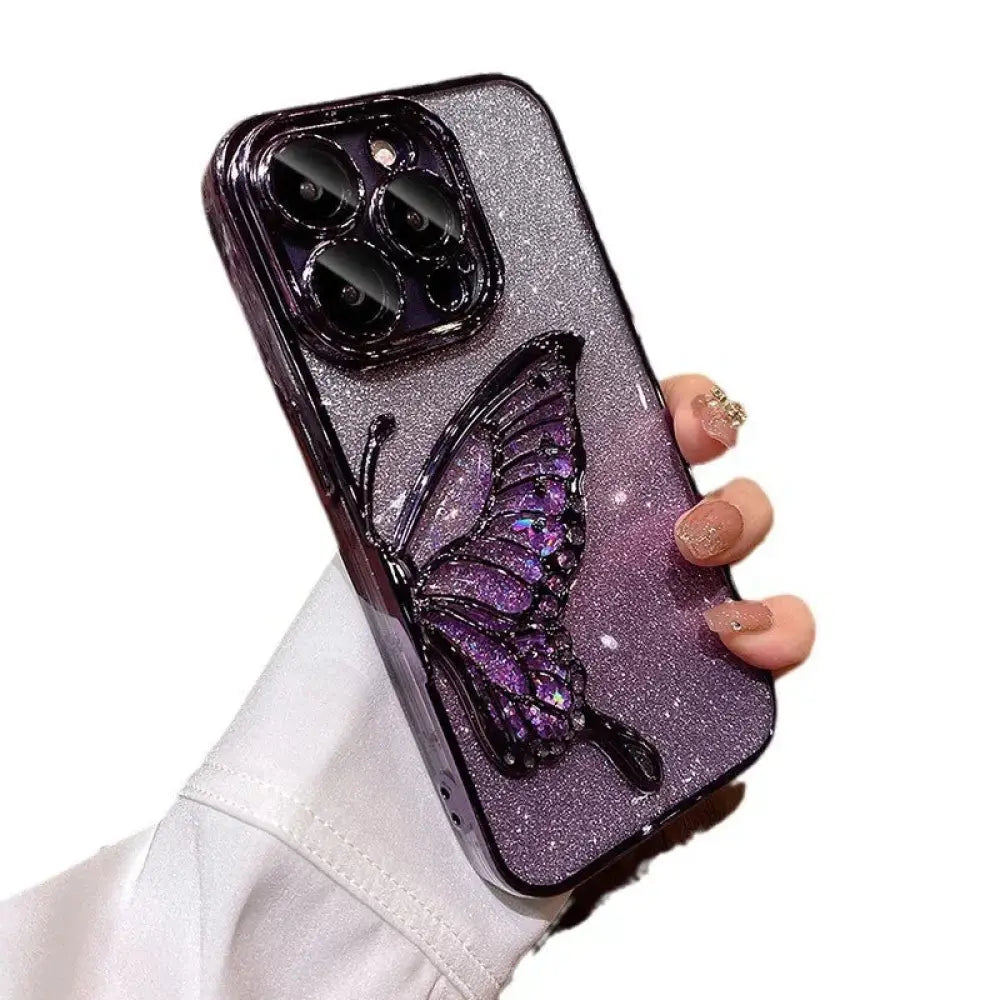 A sparkling purple glitter shatterproof quicksand butterfly crystal phone case with 3D iridescent wings held in hand