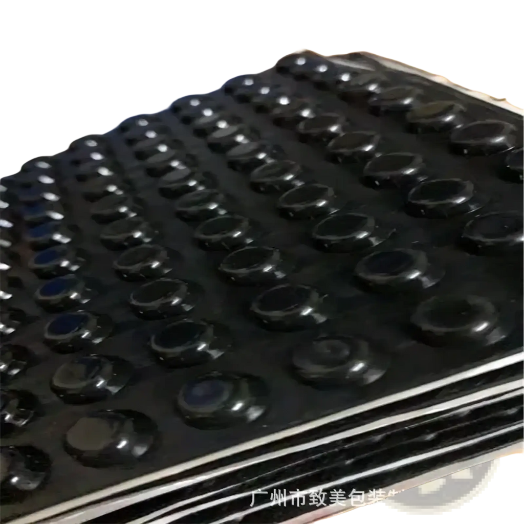 Black rubber foot pads with glossy finish arranged on stacked trays for transparent silicone furniture bumpers and pads