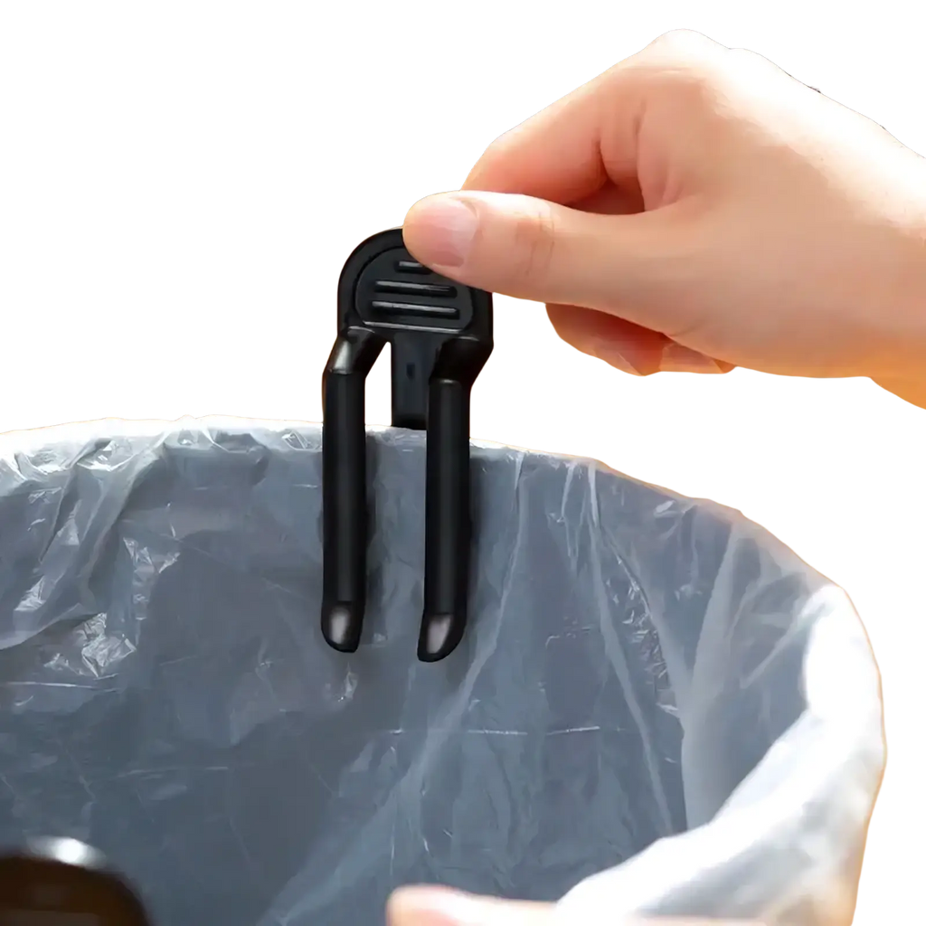 Black plastic trash bag clip with textured grip and two prongs for durable secure lid holding on bins