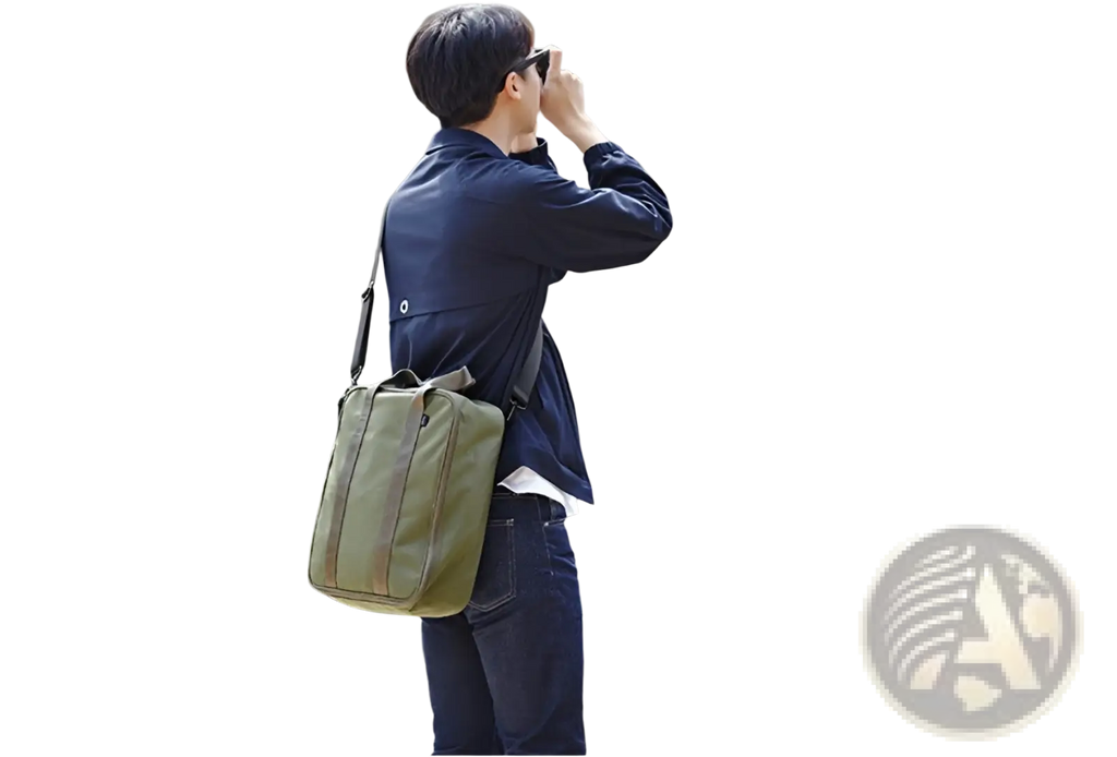 Olive green canvas shoulder travel bag with simple design and black strap made of cotton canvas for storage organization