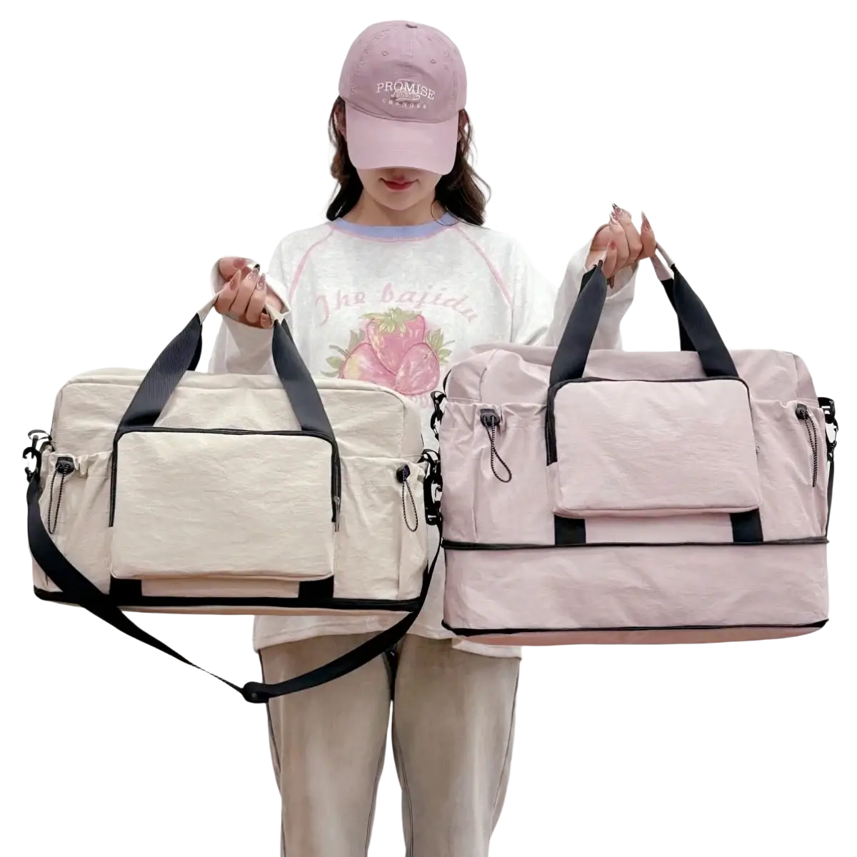 Two expandable lightweight travel duffel bags in cream with black accents and soft pink with black trim