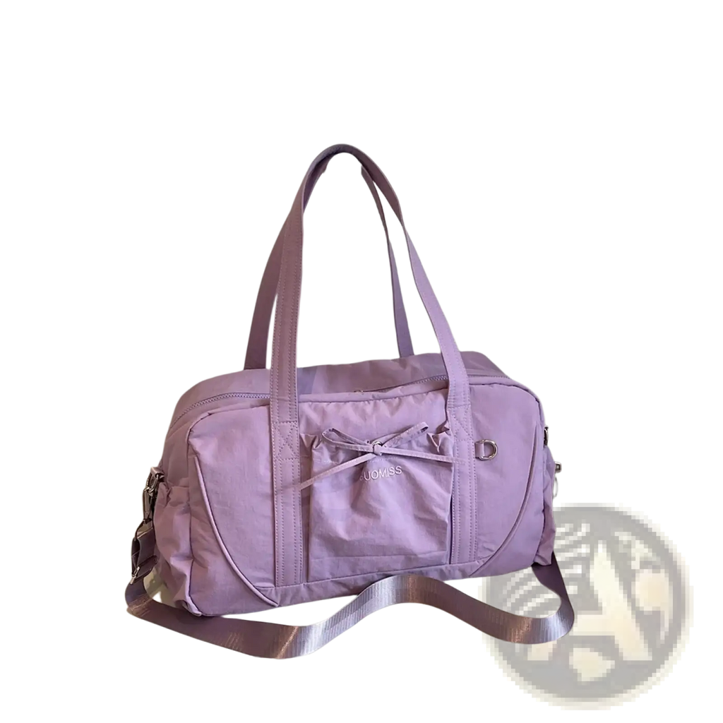 A lavender durable nylon travel duffel bag with large capacity front pocket bow detail and adjustable shoulder strap