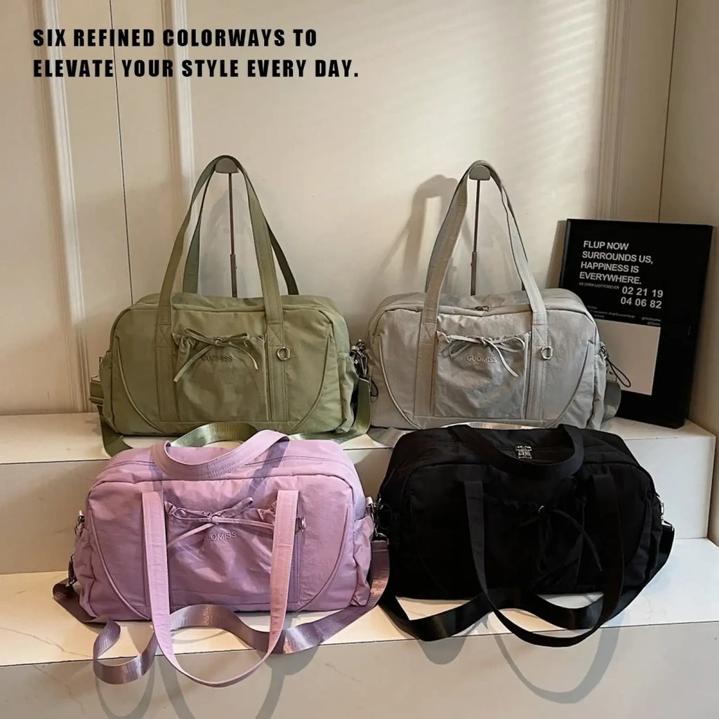 A sleek olive green soft-shell nylon travel duffel bag with large capacity and subtle bow detail for women