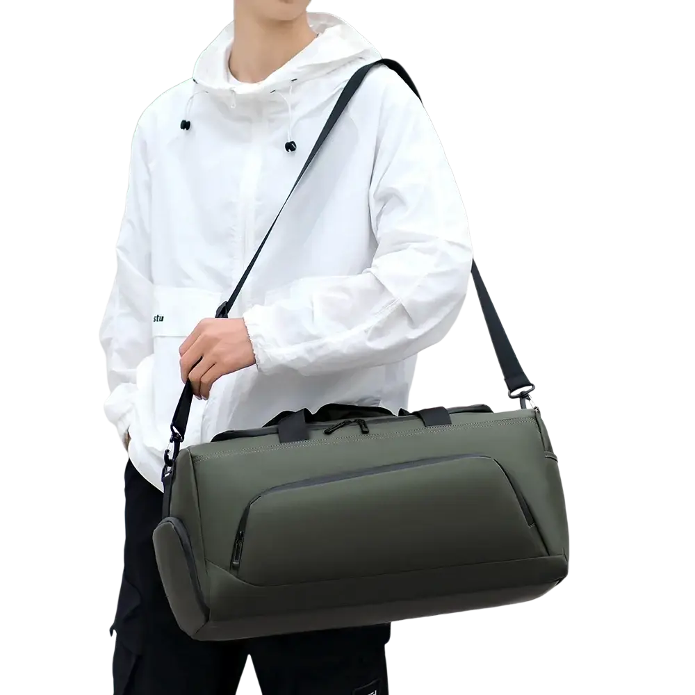 Olive green travel duffel bag with black straps zippers and shoe compartment for organized packing