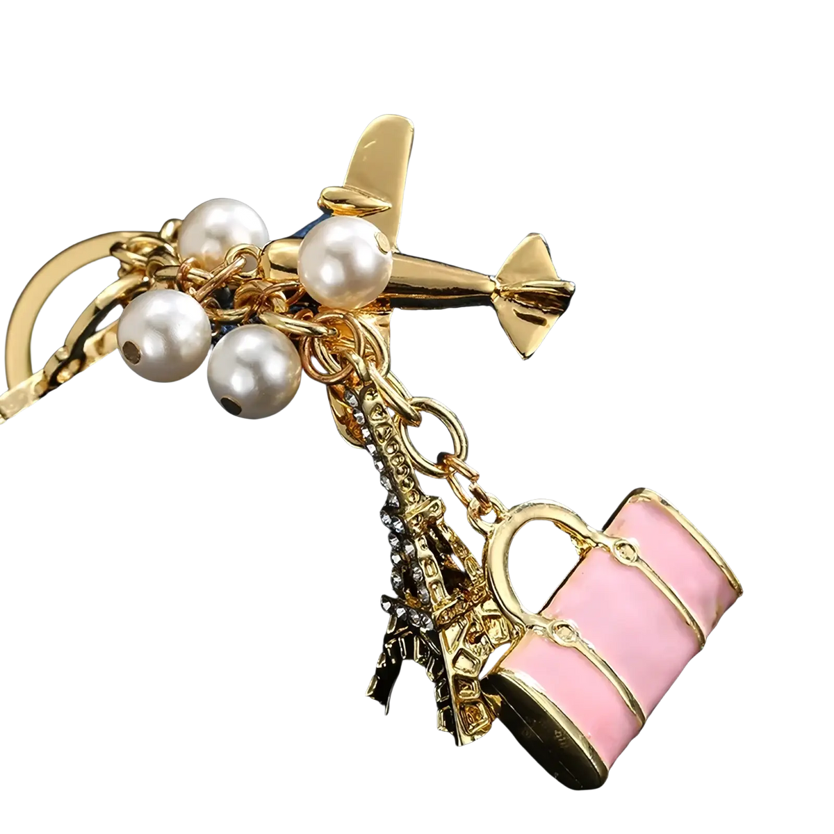 Gold-toned travel keychain with faux pearls mini airplane eiffel tower crystals and pink enamel handbag charm