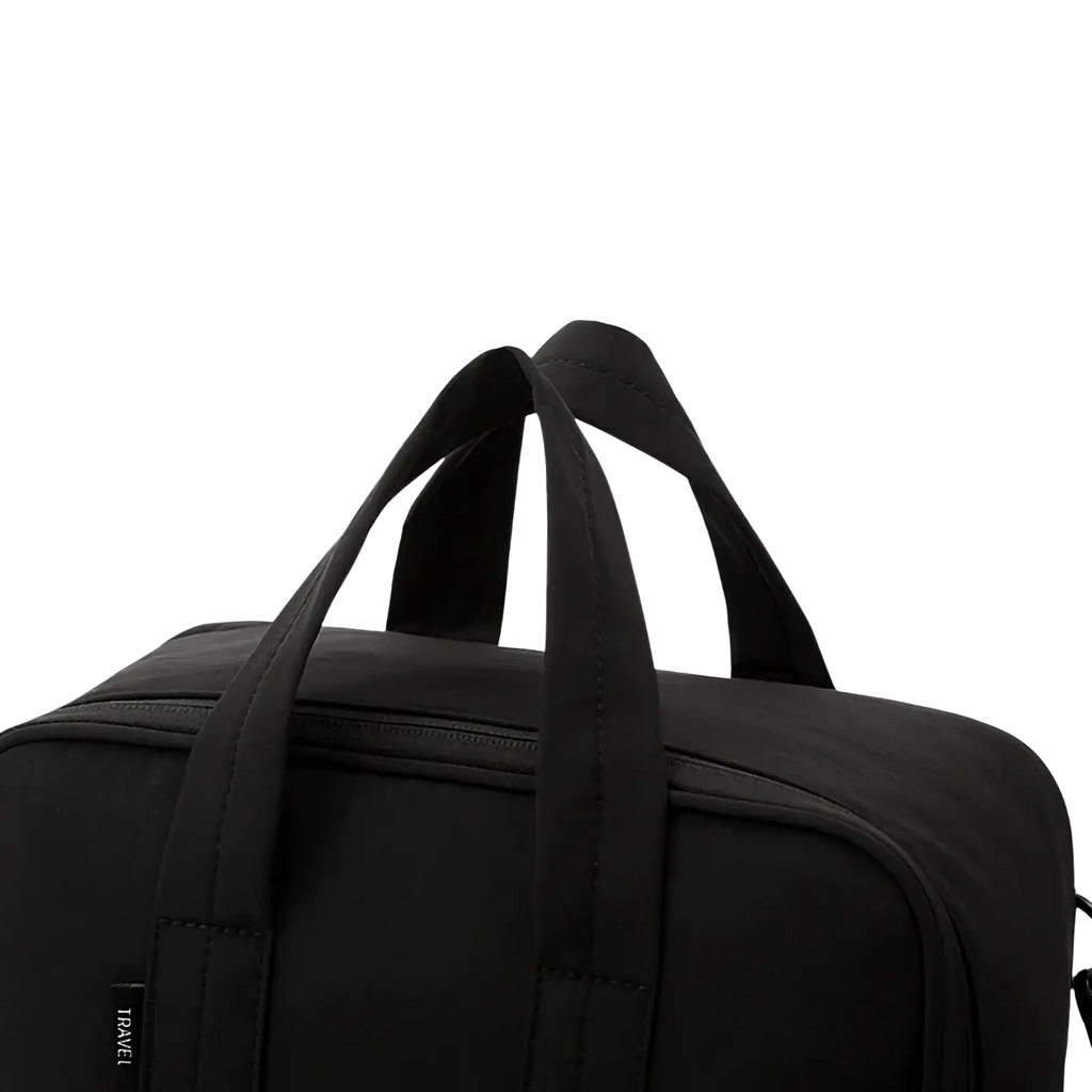 Black fabric duffel bag with sturdy handles and subtle travel tag for large capacity travel packing cube organizer
