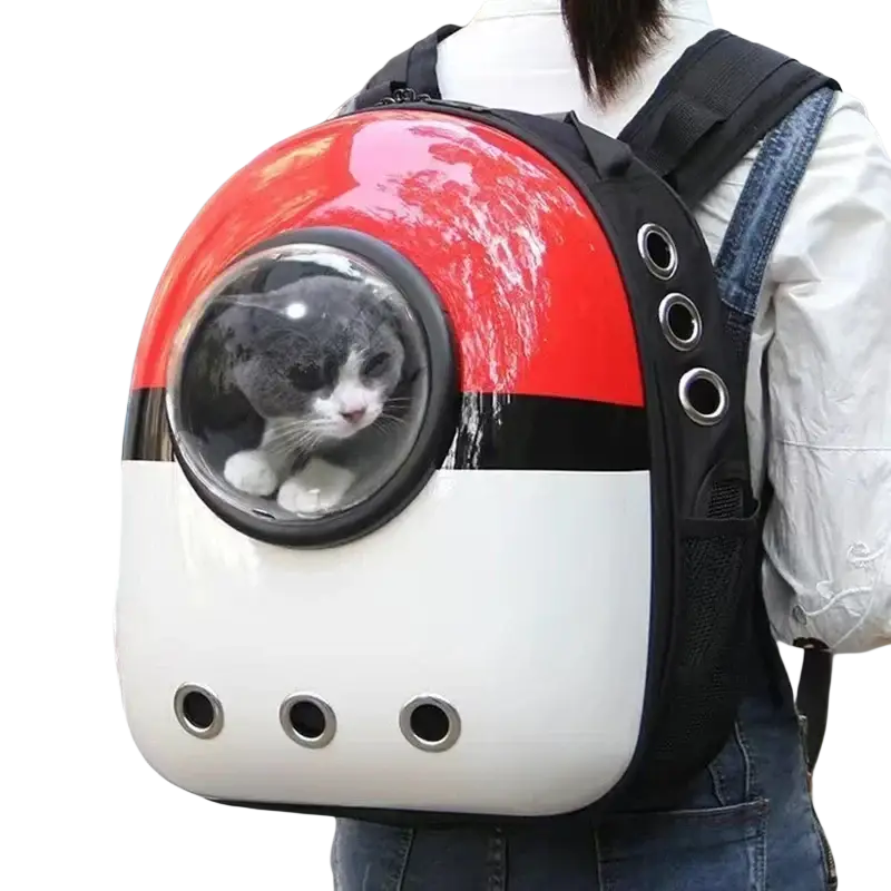 Red and white poké ball-style travel puppy cat backpack with clear dome carrier and gray and white cat inside