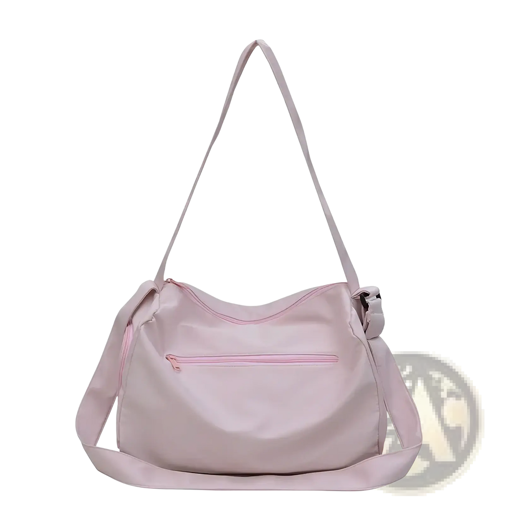 A soft blush pink lightweight nylon shoulder travel tote bag with matching zipper and adjustable strap