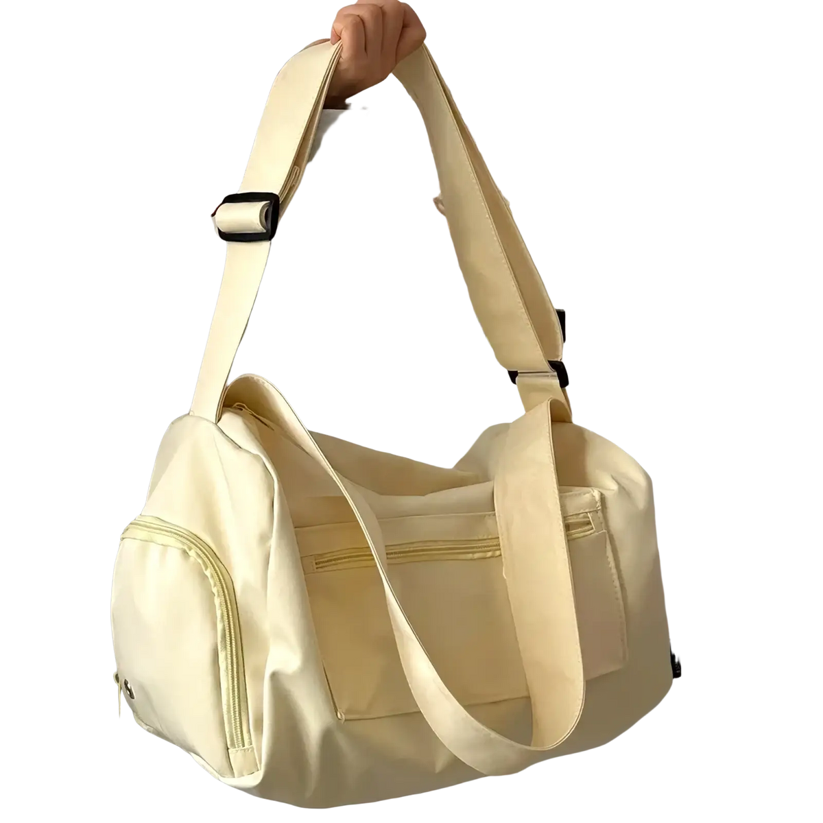 Cream-colored canvas travel tote bag with adjustable shoulder strap and multiple zippered compartments for crossbody use