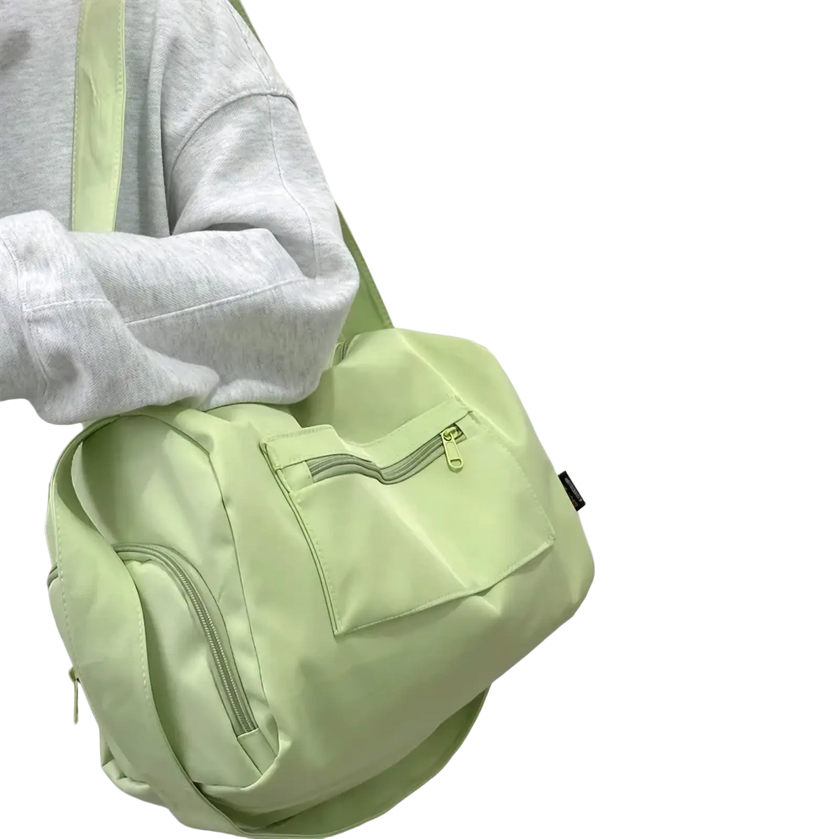 Light green nylon travel tote bag with zipper pockets and minimalist design for crossbody use