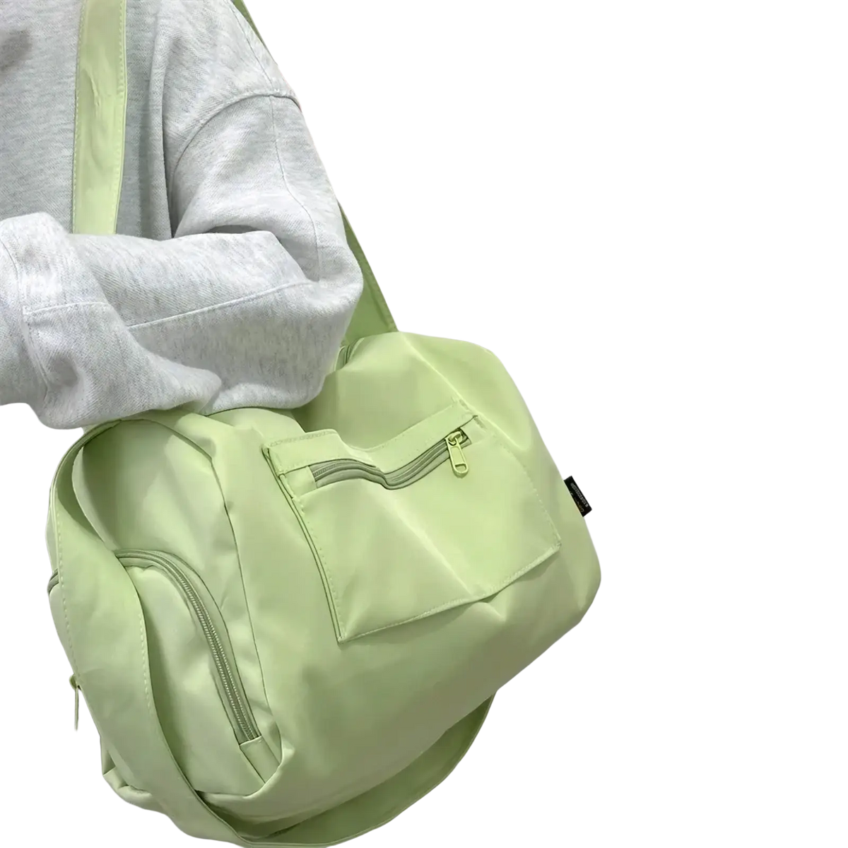 Light green nylon travel tote bag with front zippered pocket and matching shoulder strap for crossbody use
