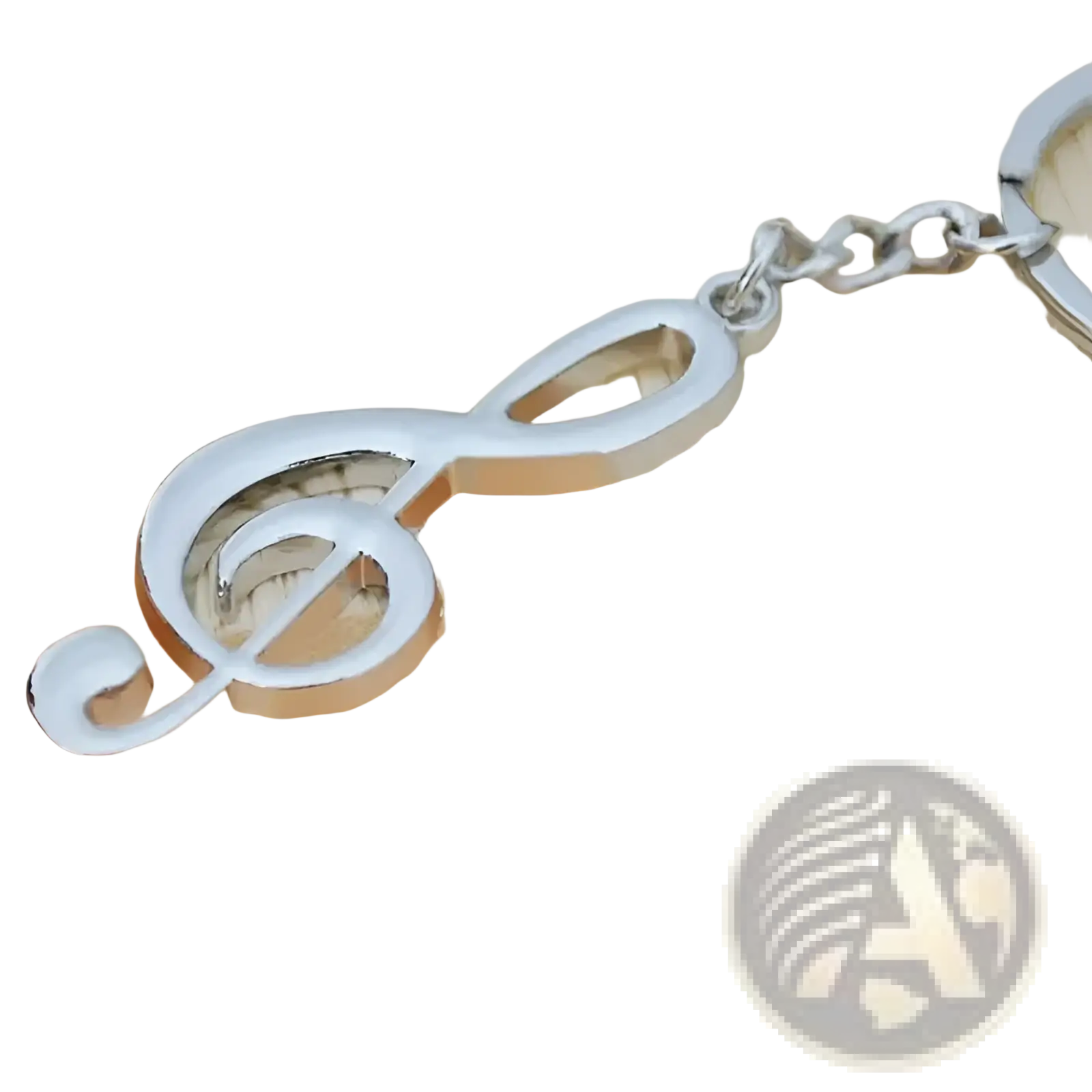 Silver metal treble clef music note keychain with polished reflective finish and attached chain