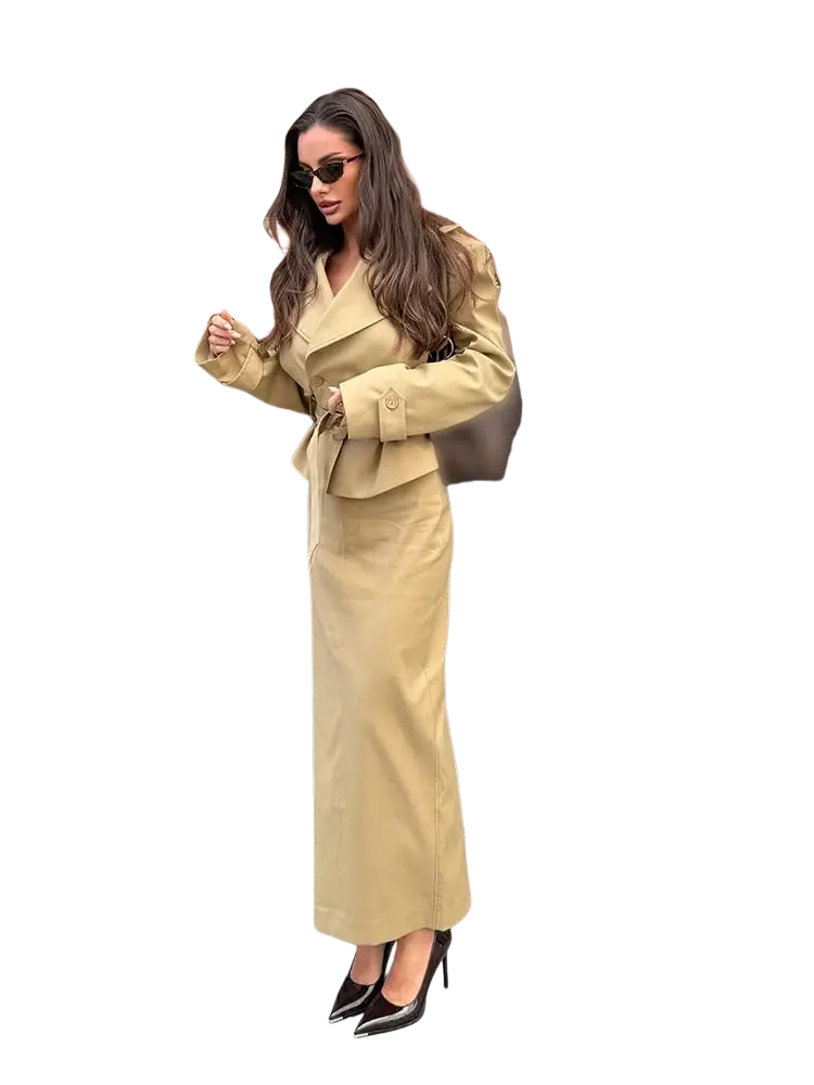 A tan trench co ord skirt set featuring a belted waist trench coat and matching high waisted trousers