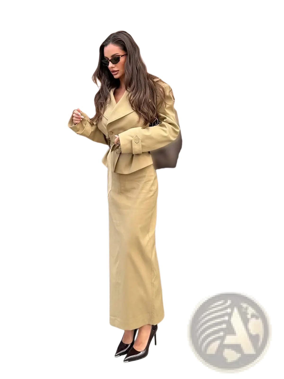 A tan trench co ord skirt set featuring a belted waist trench coat and matching high waisted trousers