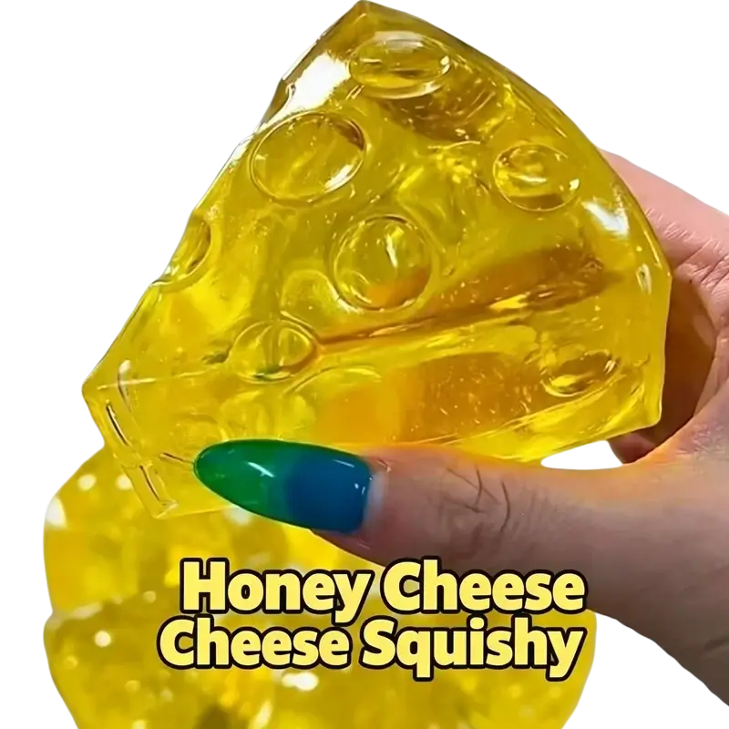 A translucent yellow mini triangle cheese fidget toy with a glossy gel-like texture and round holes for stress relief
