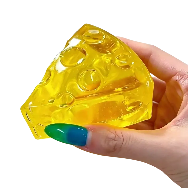 A translucent yellow mini triangle cheese fidget toy with circular holes for soft stress relief squeeze use