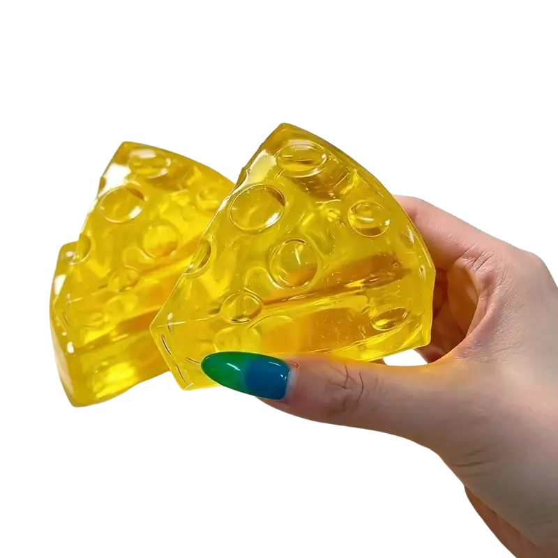 Yellow translucent mini triangle cheese fidget toy soap with embedded holes for soft stress relief squeezing