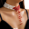 A triple layer choker necklace featuring two white and one red pearl rows with cascading red beads below