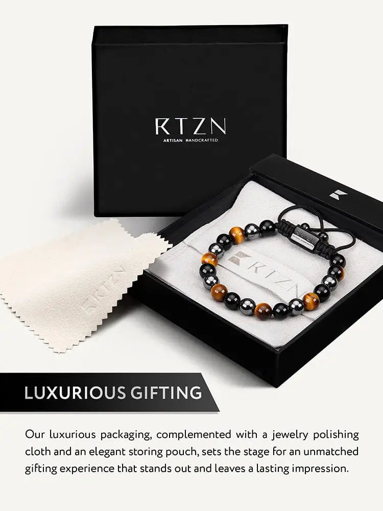 A sleek black and golden tiger eye beaded bracelet for men with silver clasp in an elegant rtzn artisan gift box