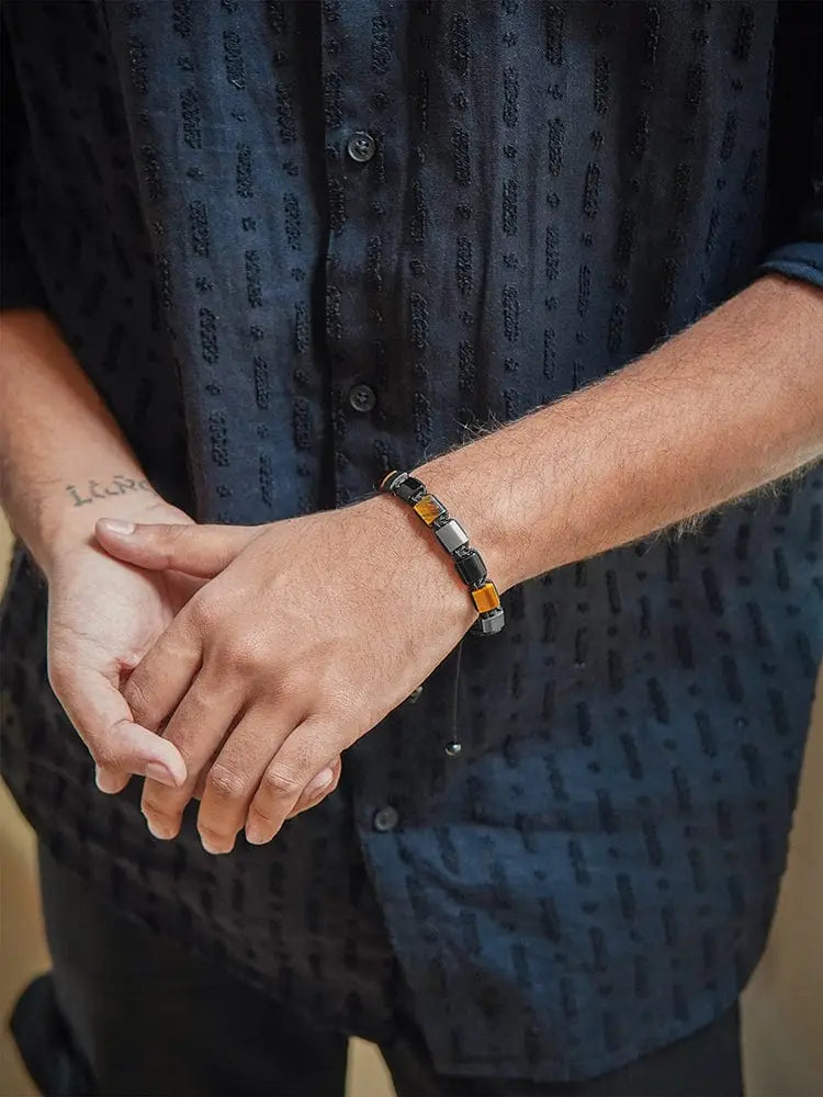 A stylish Havana triple protection bracelet with alternating black obsidian and amber-colored hematite beads