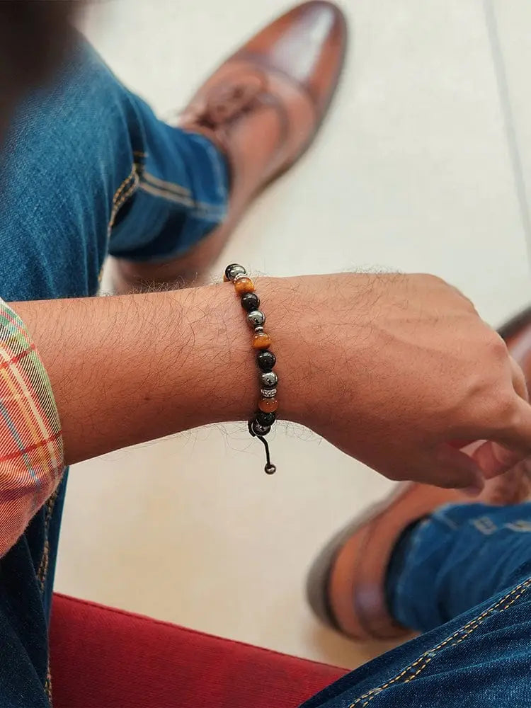 A stylish triple protection Mykonos bracelet with alternating black and orange tiger eye and hematite beads and metal clasp