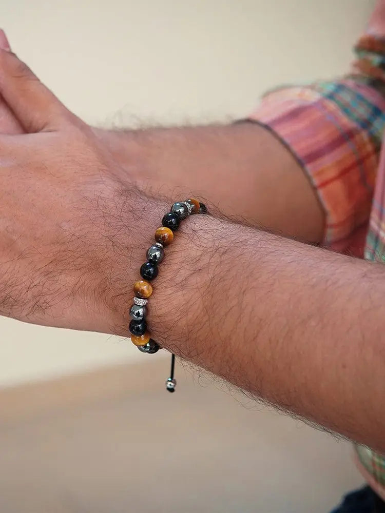 A men’s beaded bracelet with alternating tiger eye and black hematite stones and silver-toned accents