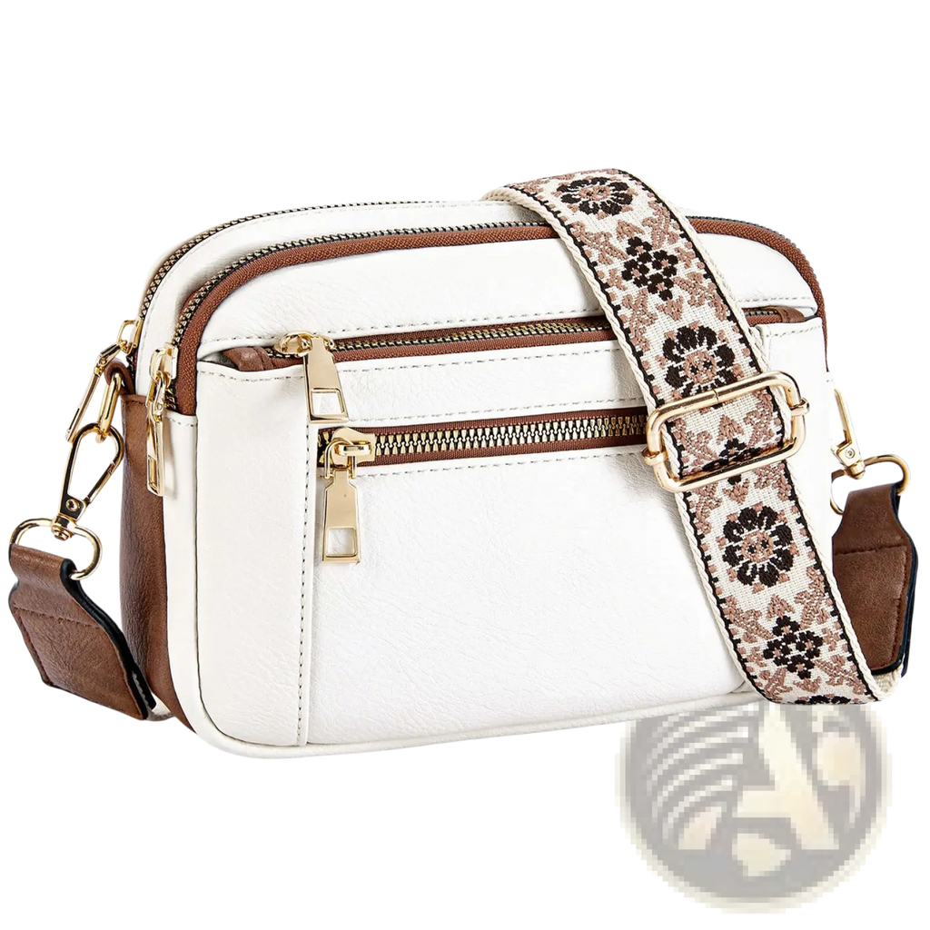White and brown colorblock crossbody camera bag with a floral-patterned triple zipper strap for versatile use