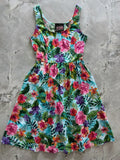 Tropical floral retro fit and flare cotton midi dress with sleeveless vibrant pink purple and orange hibiscus print on teal background