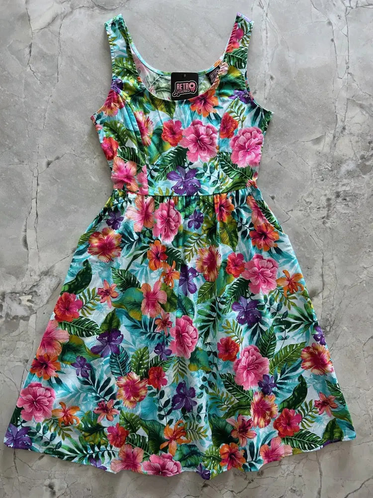 Tropical floral retro fit and flare cotton midi dress with sleeveless vibrant pink purple and orange hibiscus print on teal background